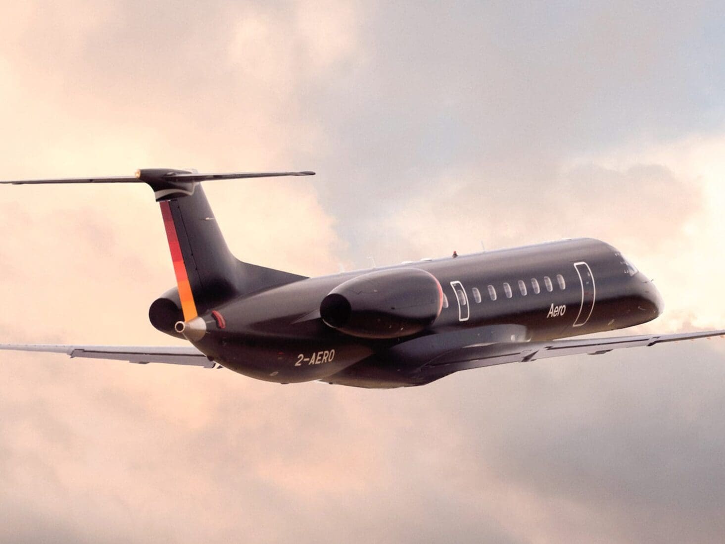 An Aero semi-private jet in flight amongst clouds