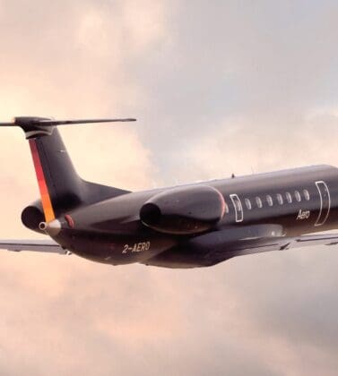 An Aero semi-private jet in flight amongst clouds