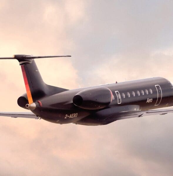 An Aero semi-private jet in flight amongst clouds