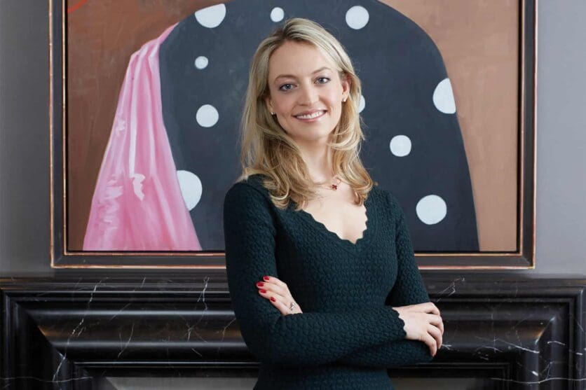 Katharine Arnold in front of George Condo's Johnny Applehead, 2009