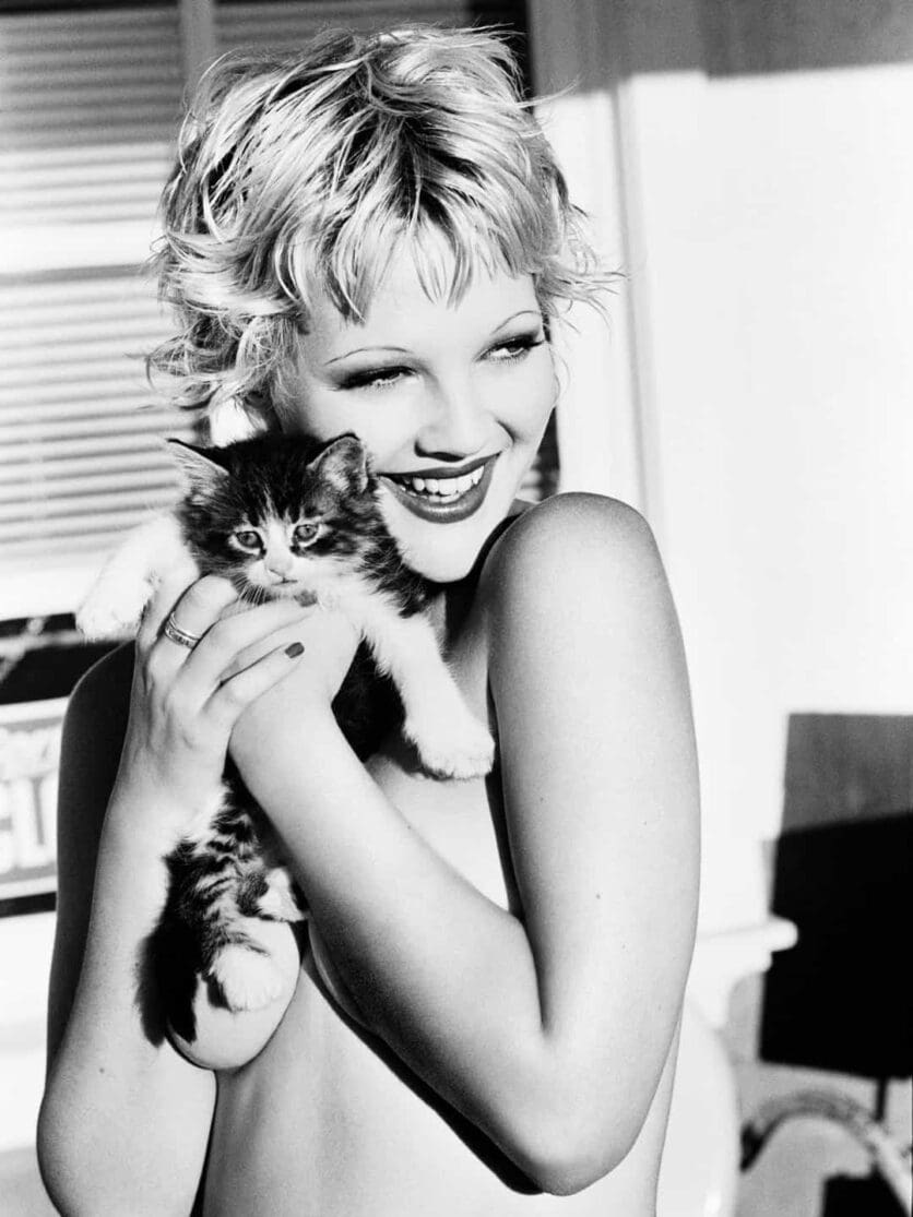 Drew Barrymore holding a kitten, black and white for Playboy 1994